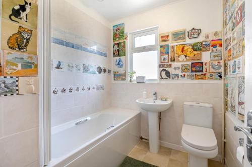 a bathroom with a sink and a toilet and a bath tub at 4 Bed in Godalming oc-b30296 in Hook