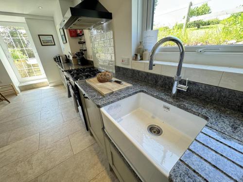 a kitchen with a sink and a counter top at 5 Bed in Gower oc-hh101 in Port-Eynon