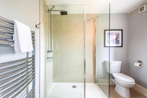 a bathroom with a toilet and a glass shower at 4 Bed in Masham oc-ds1007 in Masham