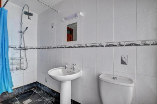 a white bathroom with a sink and a toilet at 2 Bed in Welshpool oc-wab256 in Berriew