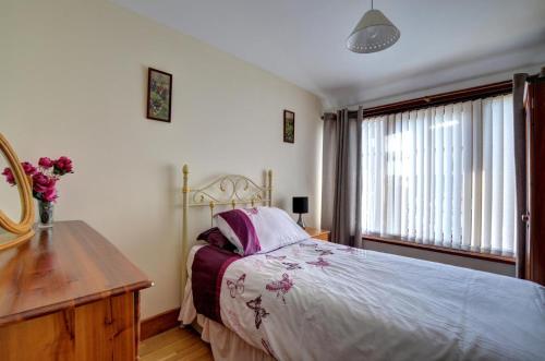 a bedroom with a bed and a dresser and a window at 2 Bed in Welshpool oc-wab256 in Berriew
