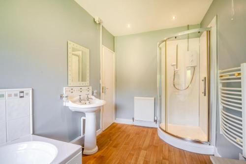 a bathroom with a sink and a shower at 3 Bed in Pwllheli oc-penmae in Pwllheli