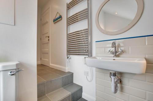 a bathroom with a sink and a mirror at 4 Bed in Pwllheli oc-lluest in Abersoch