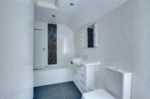 a white bathroom with a toilet and a sink at 2 Bed in Caernarfon oc-wag359 in Caernarfon