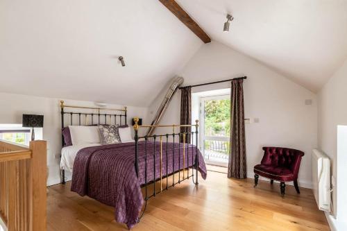 a bedroom with a bed and a chair and a window at 1 Bed in Corwen oc-fl010 in Derwen