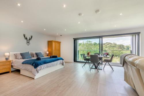 a bedroom with a bed and a desk and a large window at 1 Bed in Buxted oc-t32799 in Buxted