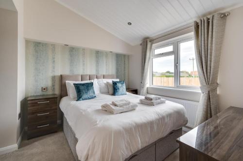 a bedroom with a large bed with towels on it at 3 Bed in Burnham Market oc-2334 in Burnham Market