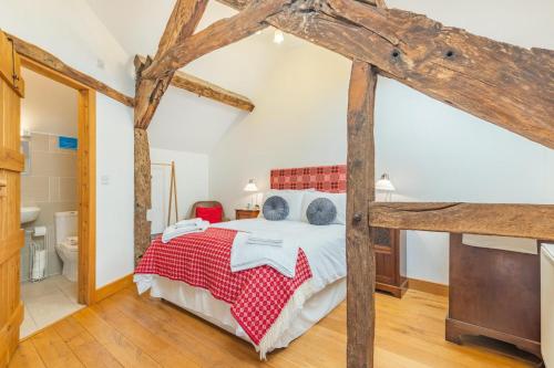 a bedroom with a large bed and wooden beams at 2 Bed in Bala oc-82768 in Llandderfel