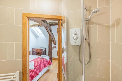 a bathroom with a shower and a bed in a room at 2 Bed in Bala oc-82768 in Llandderfel