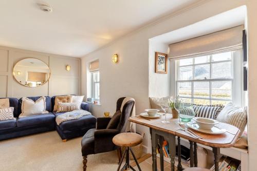 a living room with a blue couch and a table at 2 Bed in St. Ives oc-p00568 in St Ives