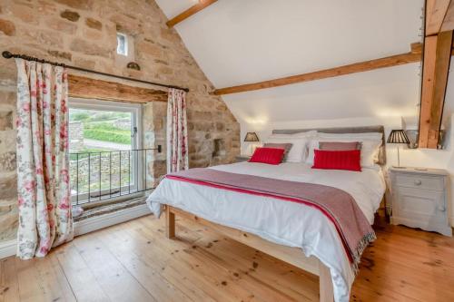 a bedroom with a large bed and a window at 2 Bed in Glaisdale oc-wa306 in Glaisdale