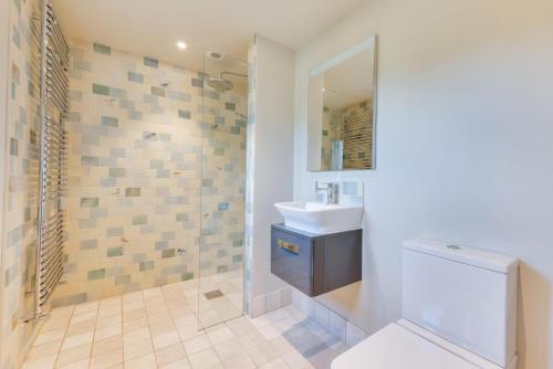 a bathroom with a sink and a toilet and a shower at 1 Bed in Middleton oc-stbc in Middleton