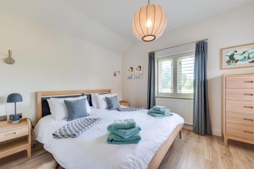 a bedroom with a large white bed with towels on it at 1 Bed in Middleton oc-stbc in Middleton