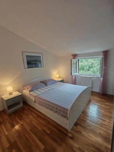 a large bedroom with a large bed and a window at Apartment Damir in Tučepi