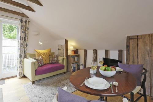 a living room with a table and a couch at 1 Bed in Woodbridge oc-tcl in Badingham
