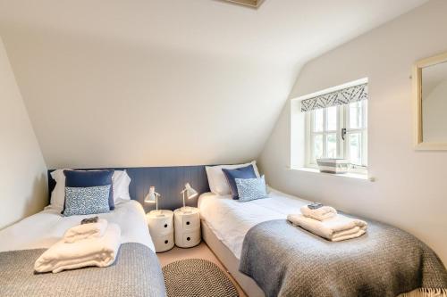 a room with two beds with towels on them at 2 Bed in Snape oc-wico in Snape