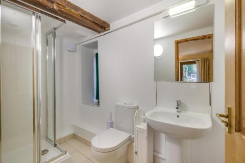 a bathroom with a toilet and a sink and a shower at 2 Bed in Smallburgh oc-h33733 in Dilham