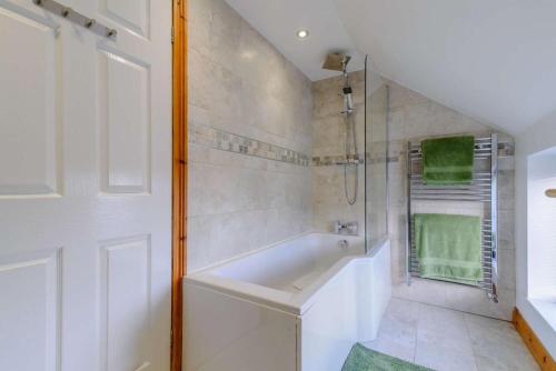 a white bathroom with a tub and a shower at 2 Bed in Dunnington oc-s34137 in Dunnington