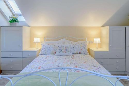 a bedroom with a bed with white dressers and two lamps at 2 Bed in Dunnington oc-s34137 in Dunnington