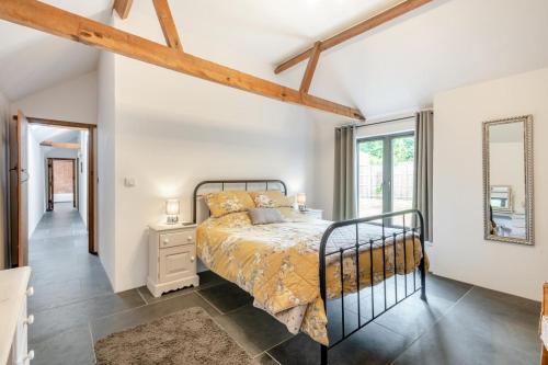 a bedroom with a bed and a large window at 3 Bed in Wood Dalling oc-caba in Wood Dalling
