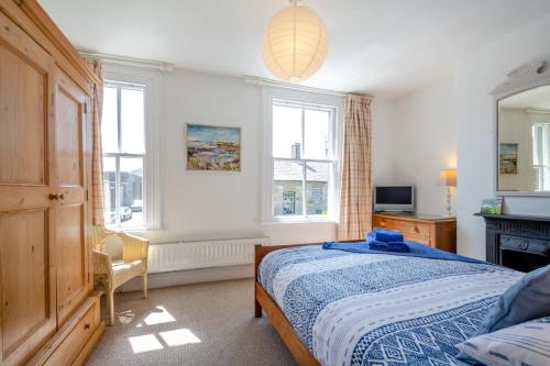 a bedroom with a bed and a television and windows at 2 Bed in Beaumaris oc-wai218 in Beaumaris
