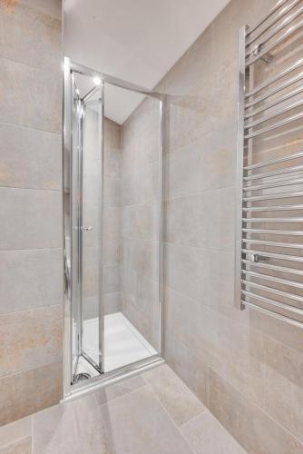 a shower with a glass door in a bathroom at 5 Bed in Briston oc-2305 in Briston