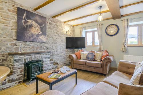 a living room with a stone wall with a fireplace at 2 Bed in Cray oc-bow287 in Cray