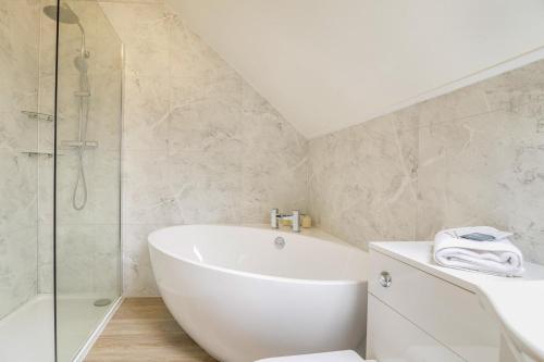 a bathroom with a white tub and a shower at 2 Bed in Cray oc-bow287 in Cray
