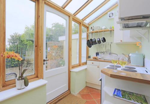 a kitchen with a window and a stove top oven at 1 Bed in Wickham Market oc-samp in Wickham Market