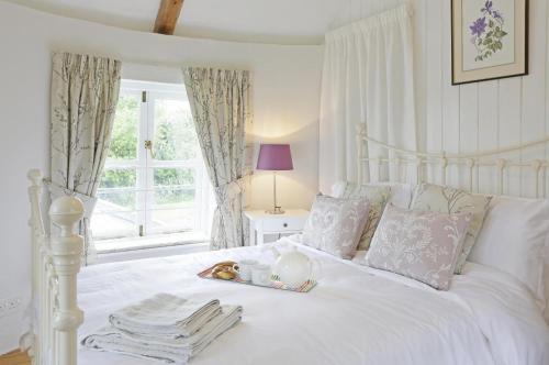 a white bed with a tray of food on it at 1 Bed in Wickham Market oc-samp in Wickham Market