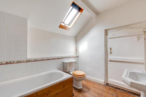 a bathroom with a tub and a toilet and a sink at 3 Bed in Tywyn oc-bow248 in Abergynolwyn