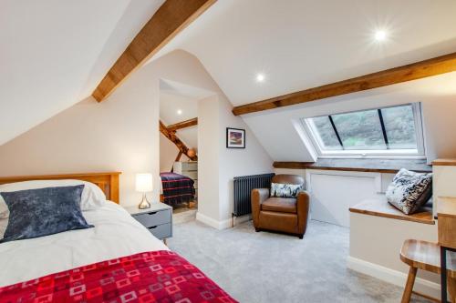 a attic bedroom with a bed and a window at 4 Bed in Dinas Mawddwy oc-bow305 in Aber Cowarch