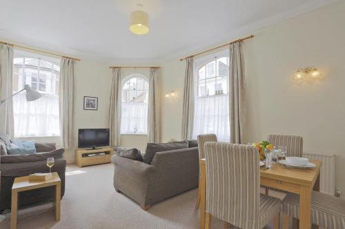 a living room with a couch and a table at 2 Bed in Southwold oc-che in Southwold