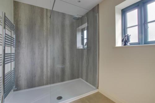 a bathroom with a shower with a glass door at 2 Bed in Weybread oc-tclwey in Needham