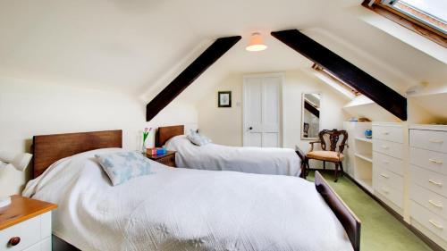a attic bedroom with two beds and a staircase at 2 Bed in Berwick-upon-Tweed oc-nb678 in Lowick