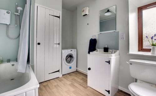 a white bathroom with a washing machine and a sink at 2 Bed in Berwick-upon-Tweed oc-nb678 in Lowick