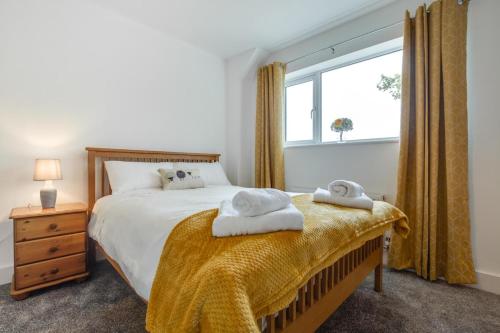 a bedroom with a bed with two towels on it at 3 Bed in Llanfynydd oc-pw9215 in Llanfynydd