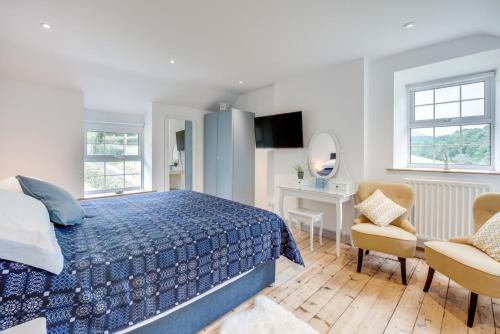 a bedroom with a blue bed and a desk at 2 Bed in Dinas Mawddwy oc-bow268 in Machynlleth