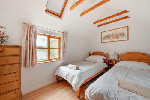 a bedroom with two beds and a window at 4 Bed in Saxmundham oc-oth in Dunwich