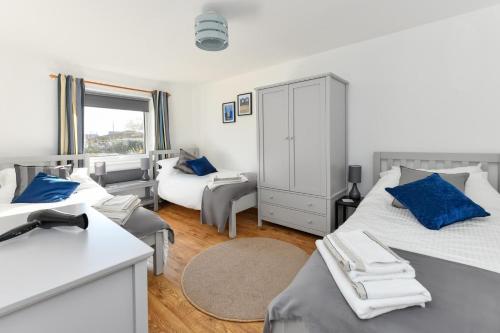 a bedroom with two beds with blue pillows at 2 Bed in Abersoch oc-147cae in Abersoch