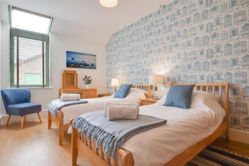 two beds in a room with a wall mural at 2 Bed in Holt oc-2274 in Holt