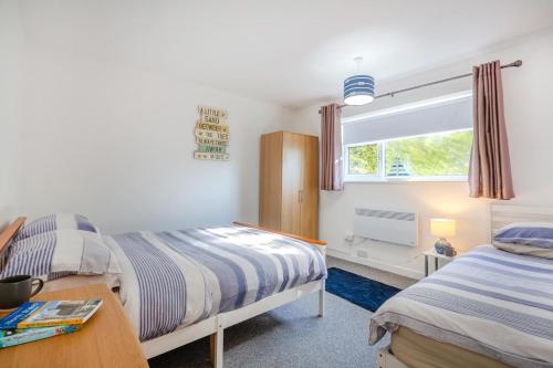 a bedroom with two beds and a window at 2 Bed in Abersoch oc-23caed in Abersoch
