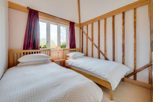 two twin beds in a room with a window at 2 Bed in Beckley oc-rh1116 in Beckley