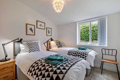 a bedroom with two beds and a window at 4 Bed in Slindon oc-t29883 in Eccleshall
