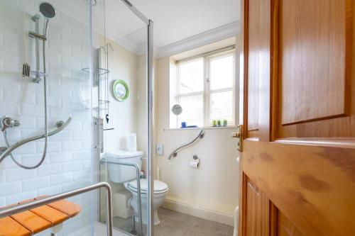 a bathroom with a toilet and a glass shower at 2 Bed in Reydon oc-aatheh in Reydon