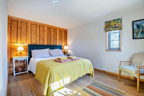 a bedroom with a bed and a chair and a window at 1 Bed in Builth Wells oc-p27441 in Builth Road