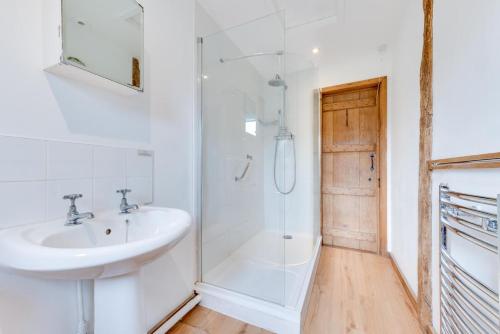 a white bathroom with a sink and a shower at 2 Bed in Biddenden oc-cb559 in Biddenden