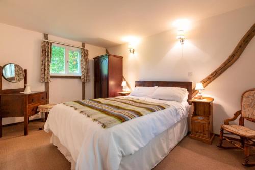 a bedroom with a bed and a dresser and a window at 2 Bed in Biddenden oc-cb559 in Biddenden