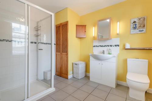 a bathroom with a shower and a toilet and a sink at 3 Bed in Swanage oc-wy272 in Swanage