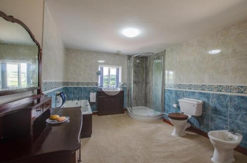 a bathroom with a toilet and a shower and a sink at 4 Bed in Cray oc-bow288 in Cray
